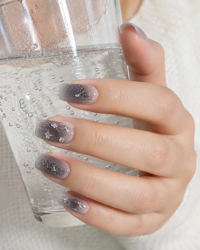 Dark Starburst Press-On Nails worn on hand