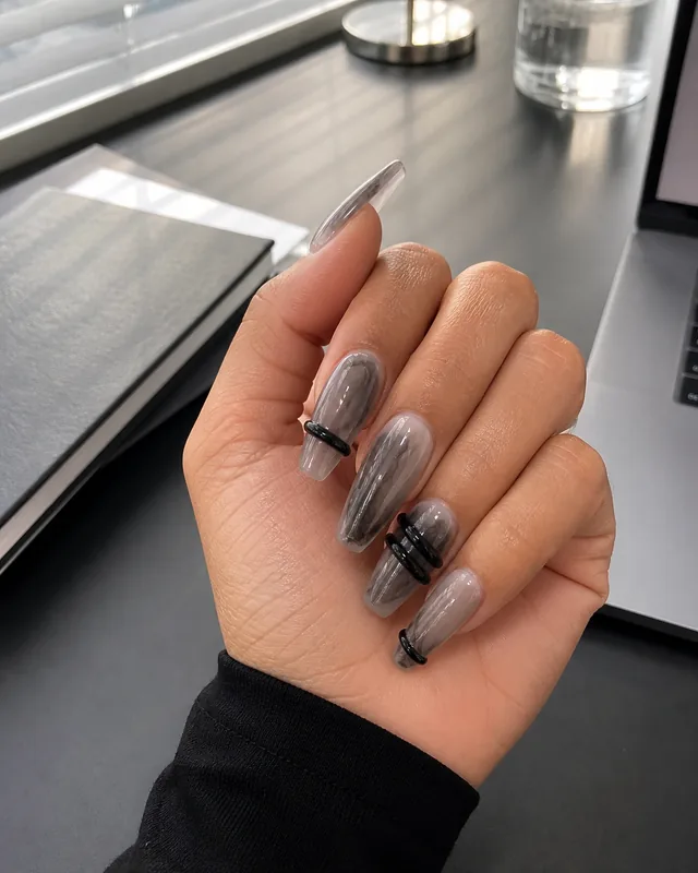 Black Wrapped Lines Press-On Nails worn on hand