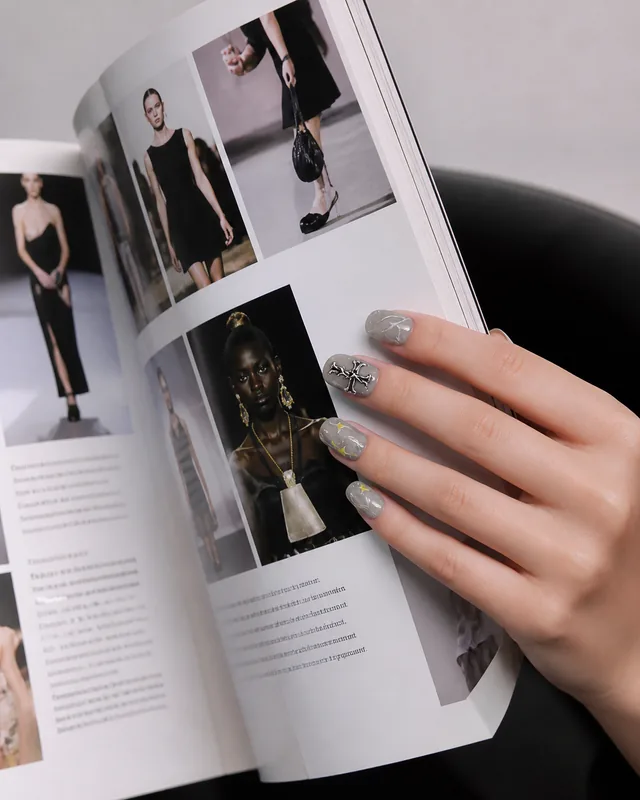 Cool Gray Starburst Press-On Nails worn on hand